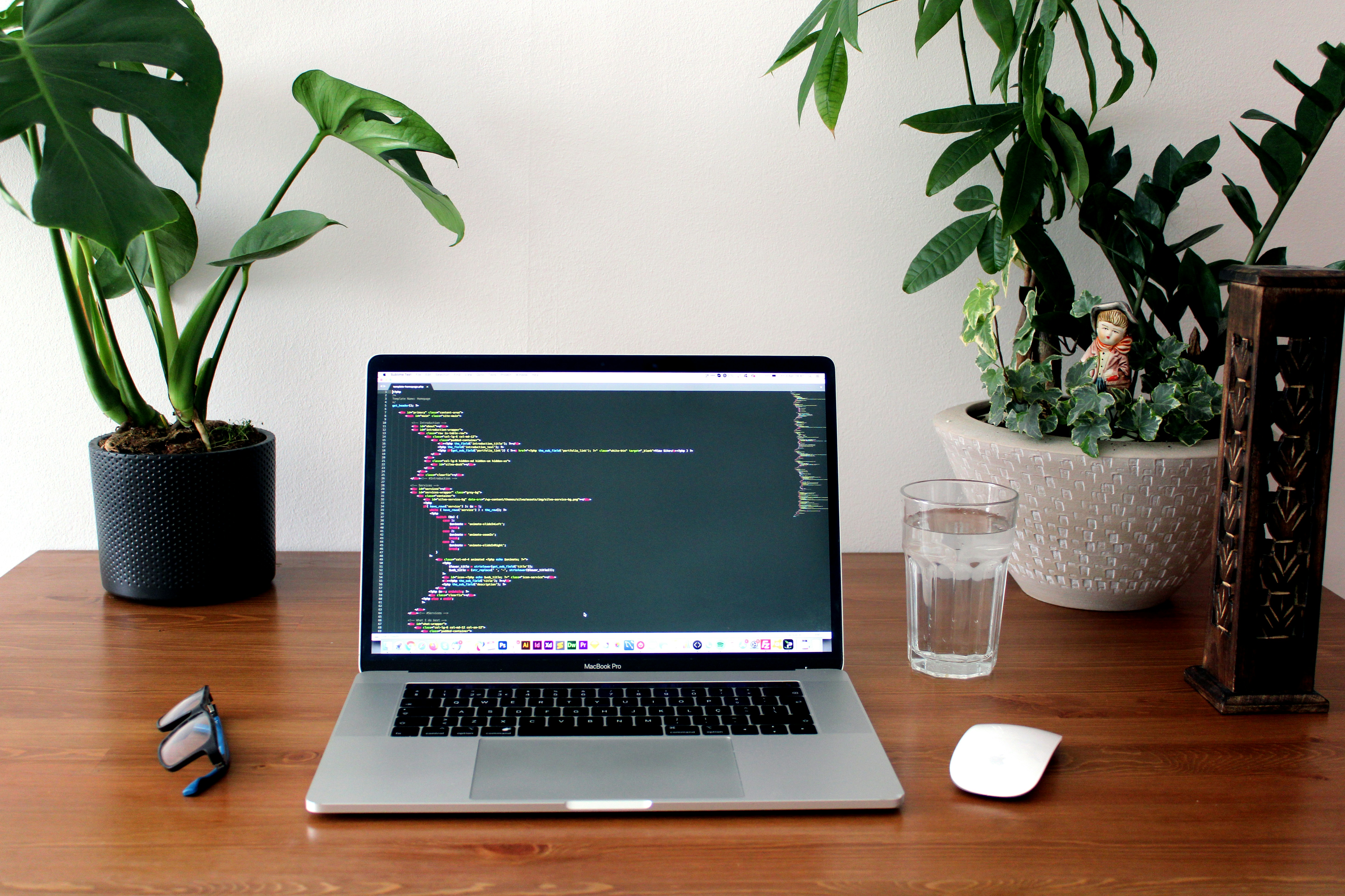 Laptop on a wooden table with a code editor open